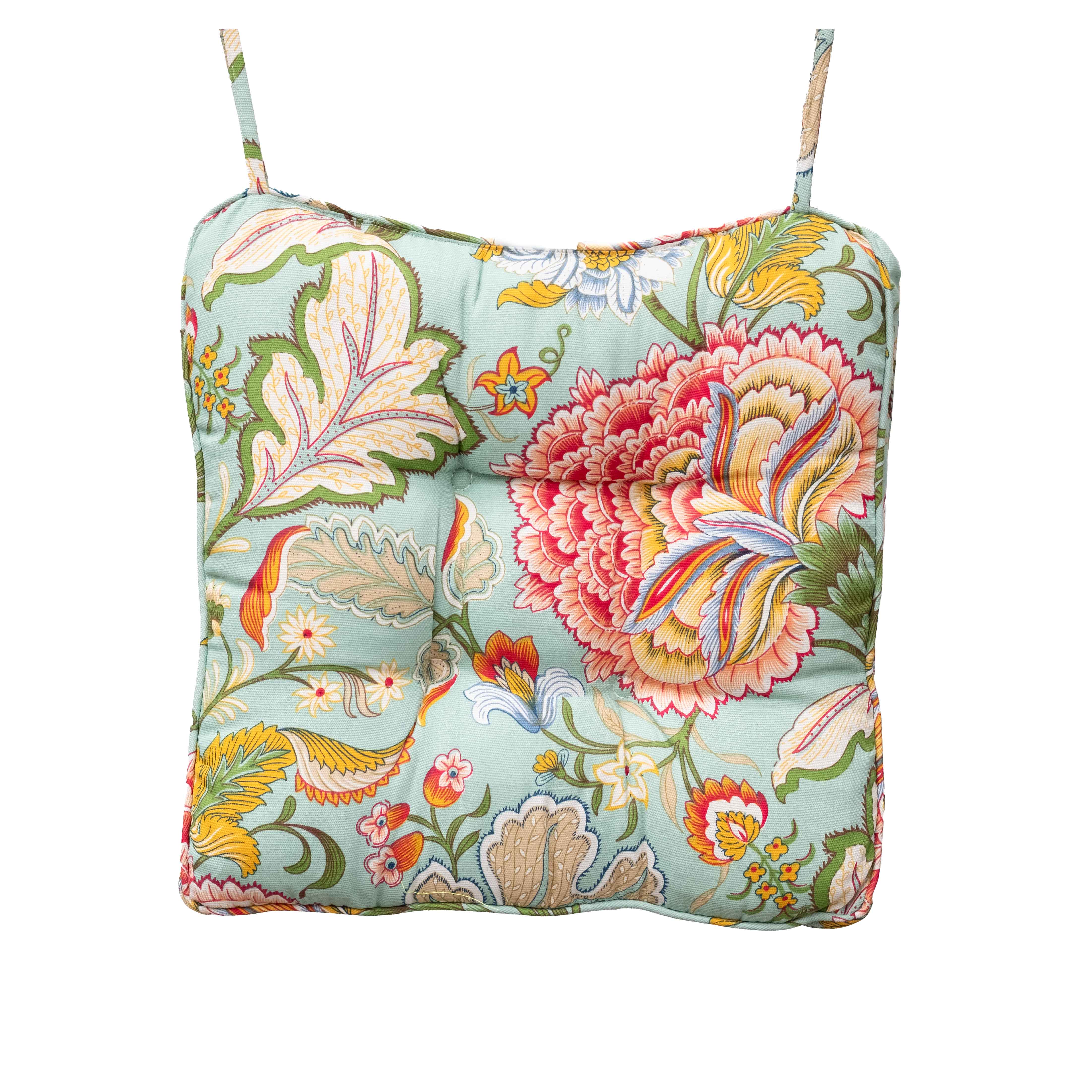 Floral patterned cushion with straps on a white background